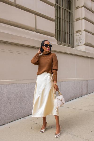 22. Brown Outfit with camel sweater and ivory satin midi skirt