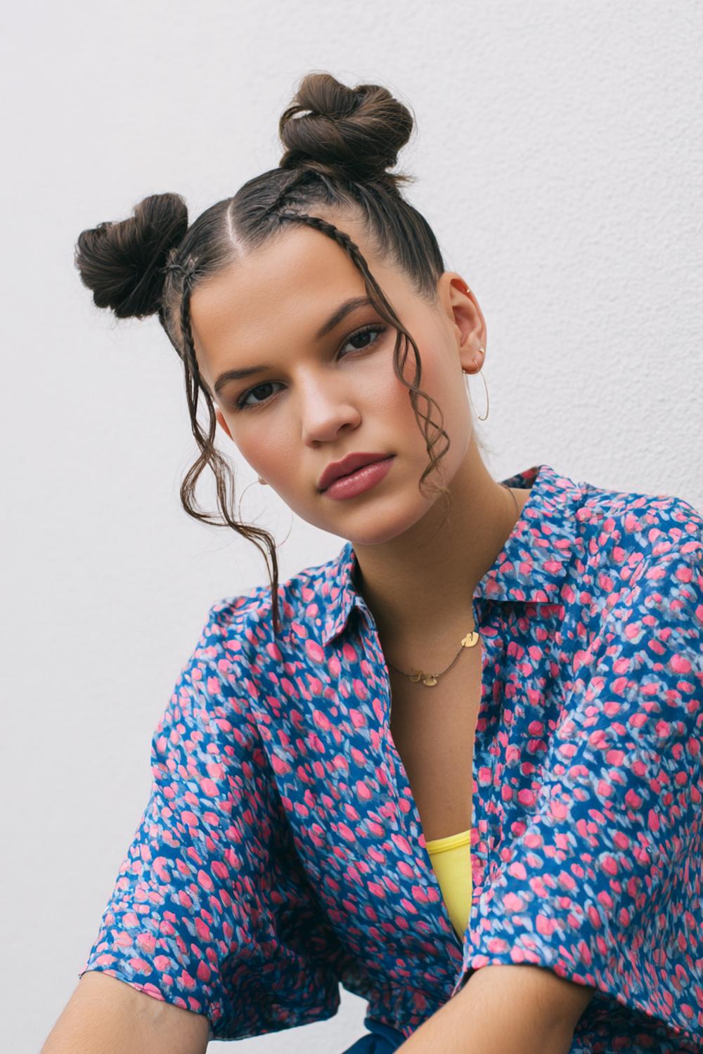 7. Cute braided hairstyles: Braided space buns with braided parting