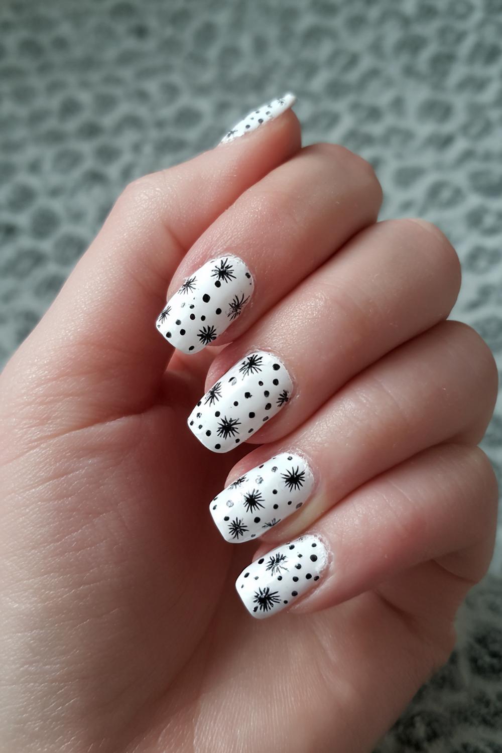 14. Black and White Nails with Tiny Starbursts on White