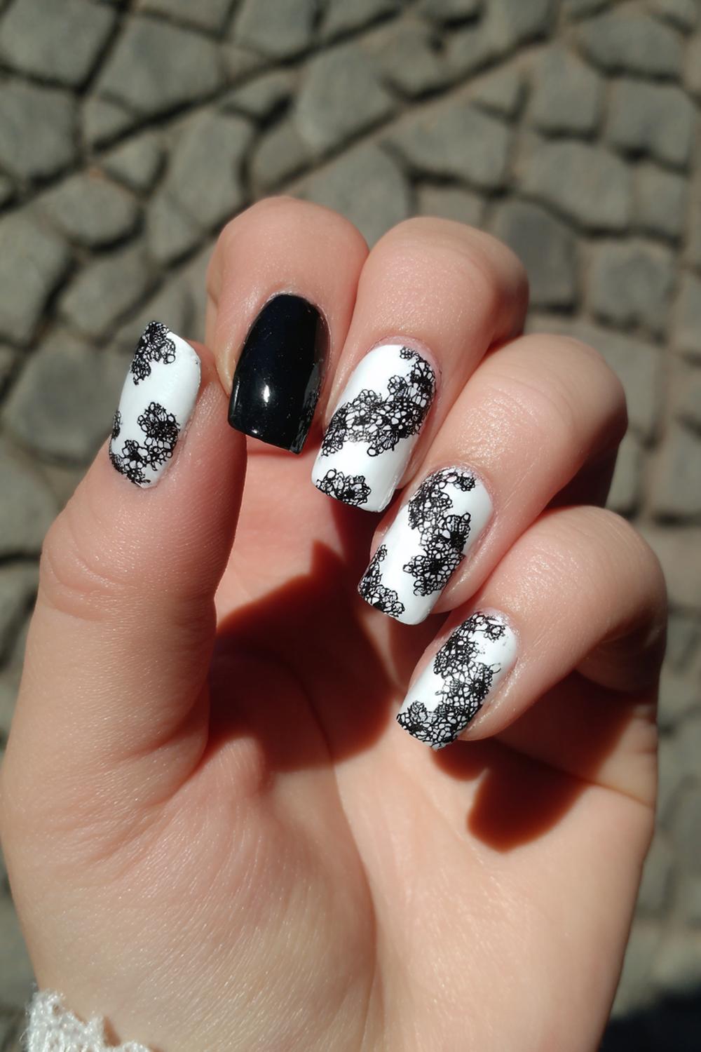 16. Black and White Nails with Elegant Lace-Inspired Stamping