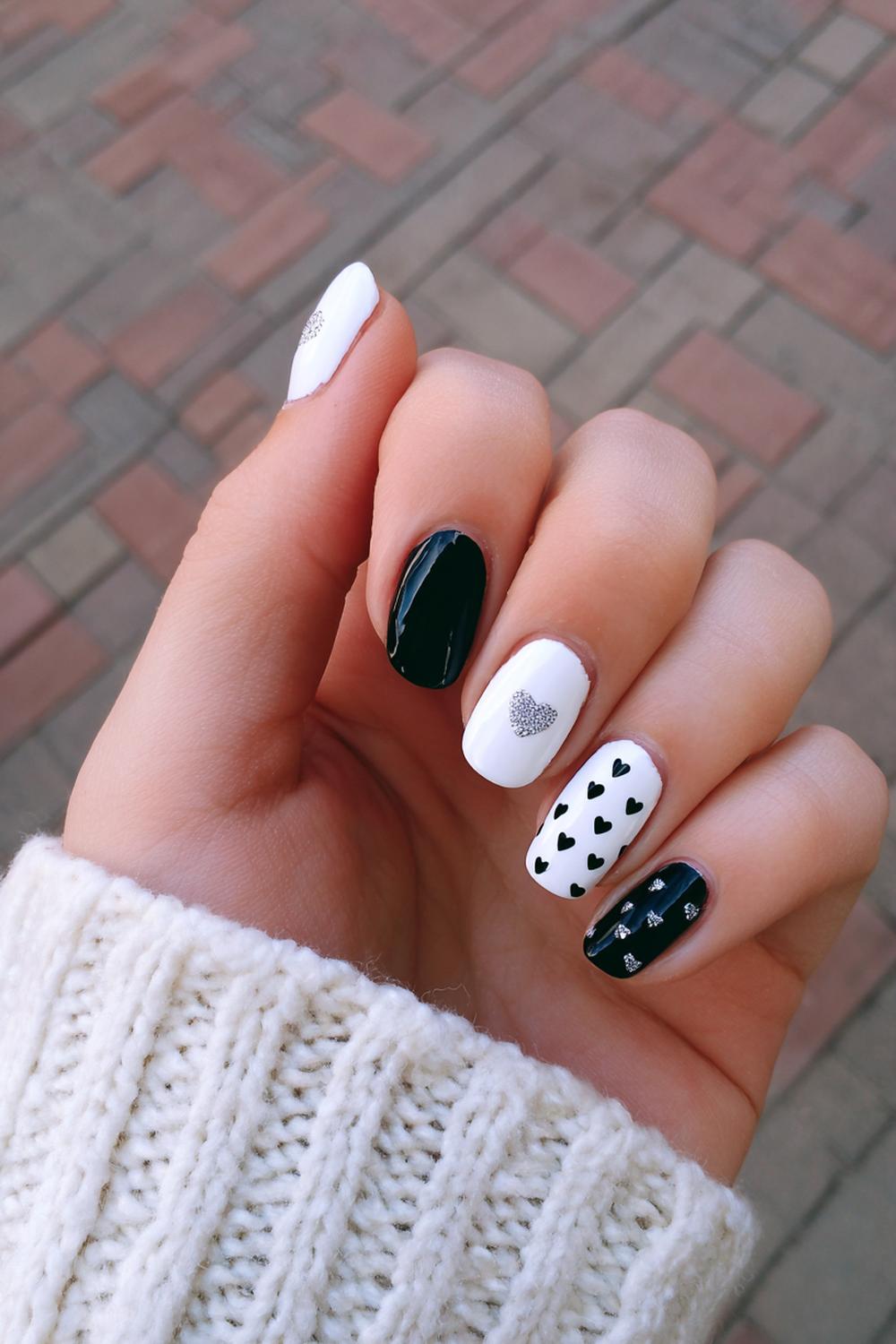 5. Black and White Nails with Tiny Heart Nails on Ring Fingers