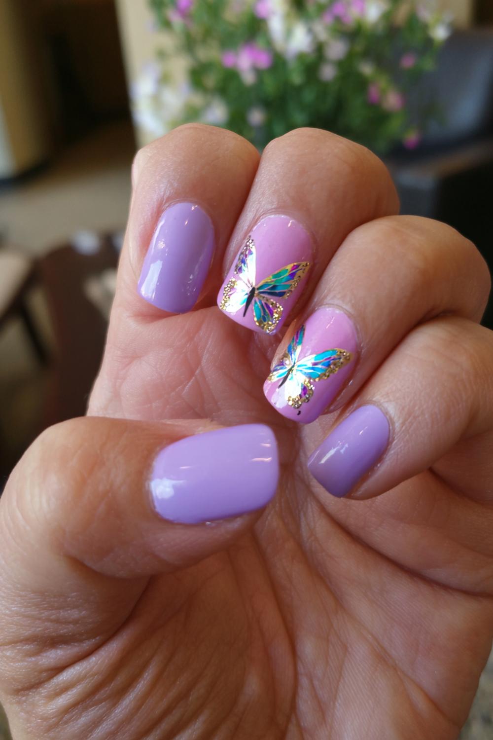 18. Nails for kids with lavender base and butterfly wing accents