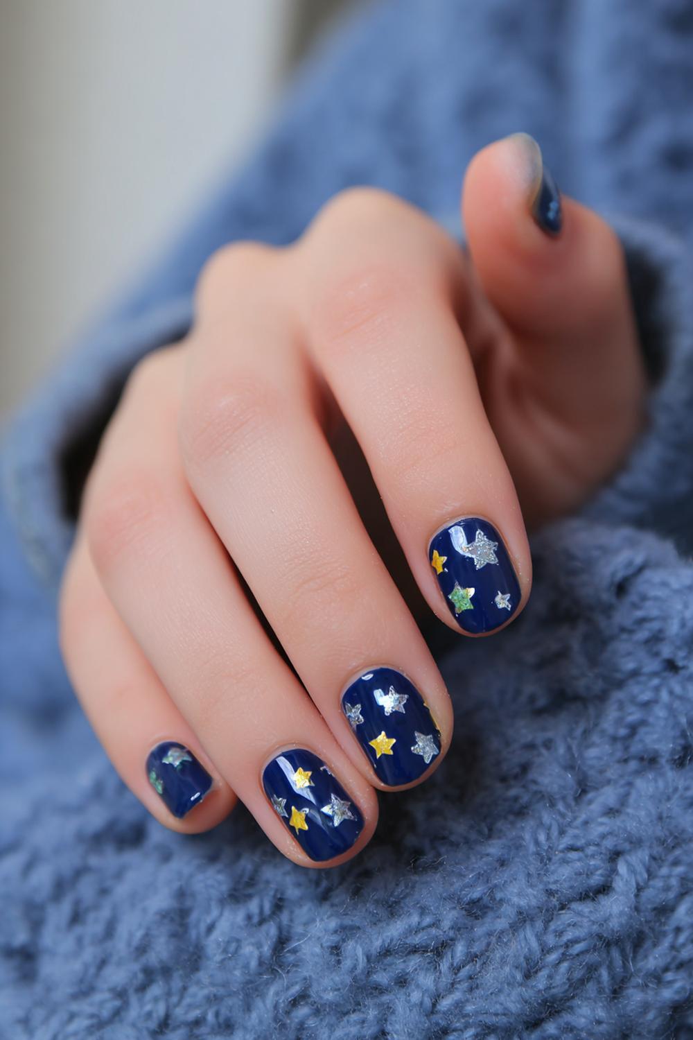 22. Nails for kids with space theme: navy base and tiny stars