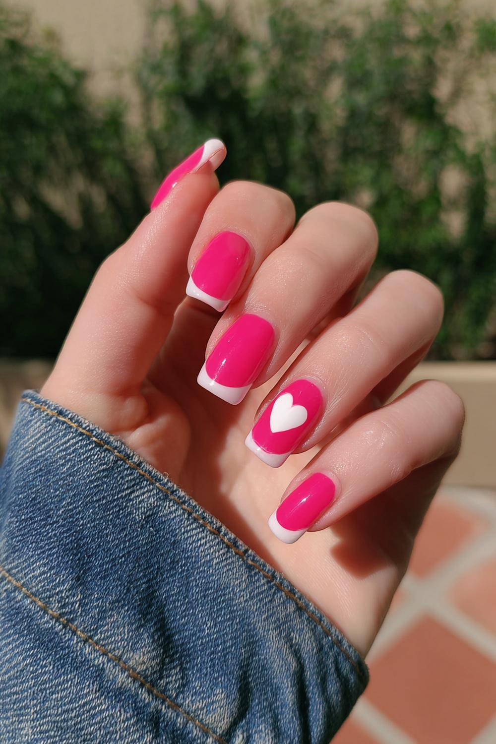 18. Simple Pink French Tip Nails with One Heart Accent