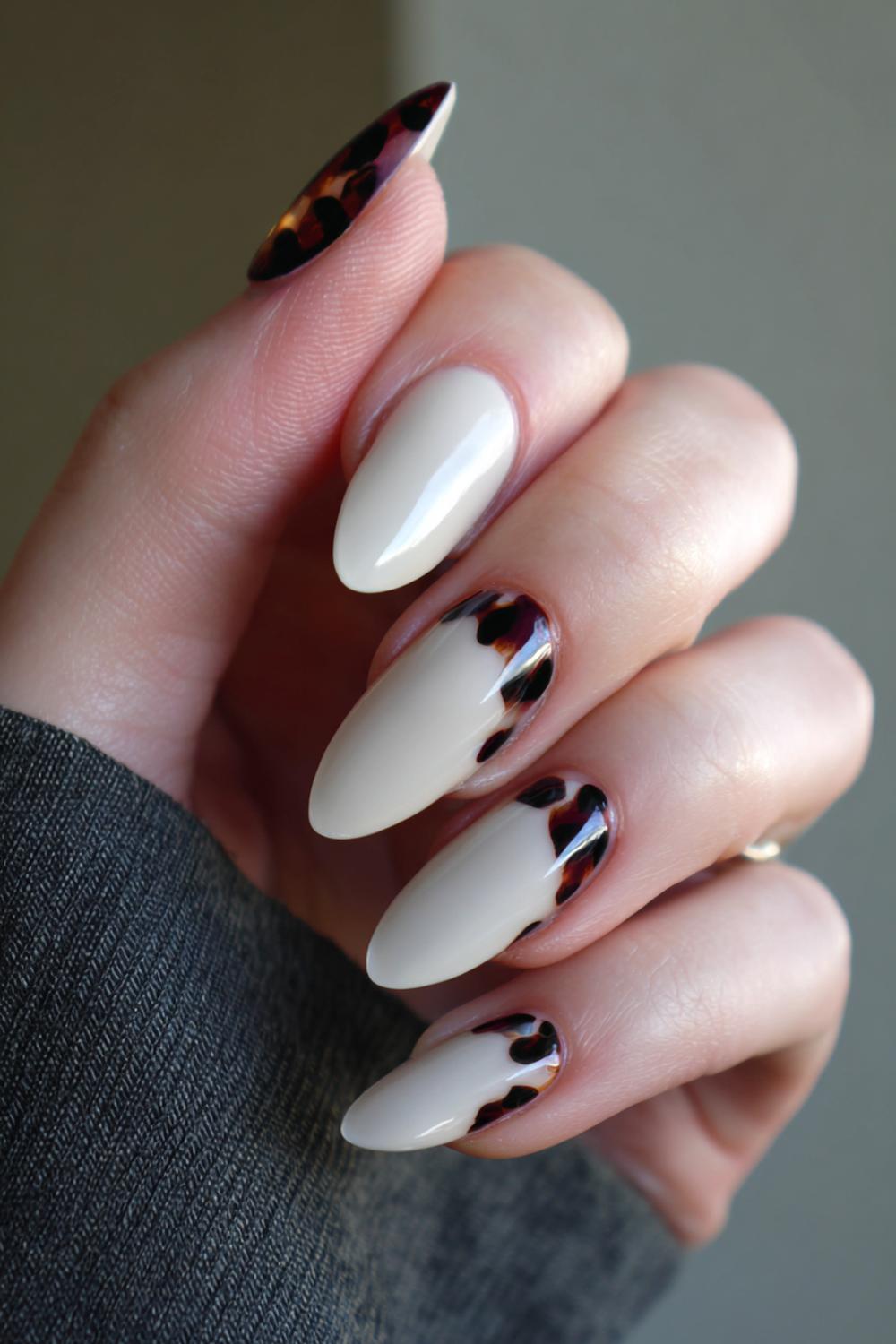 25. Medium Almond Shape Nails: Creamy Ivory with Black Tortoiseshell Accent