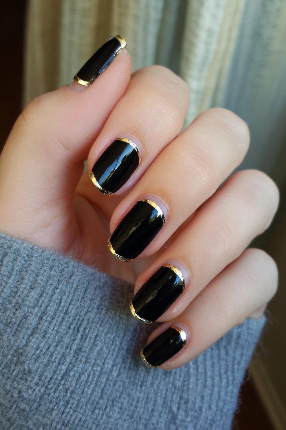 9. Nail Ideas Black And Gold: Black Tips with Gold Pinstripe Smile Line